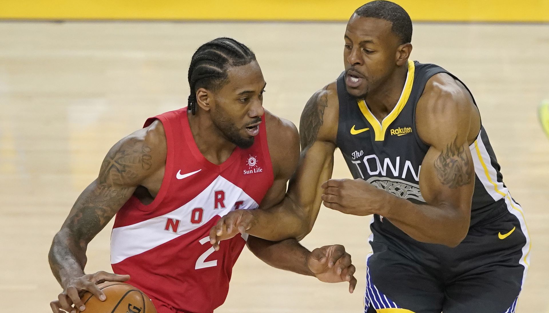 epa07646928 Toronto Raptors player Kawhi Leonard (L) drives against Golden State Warriors player Andre Iguodala (R) during the first half of the NBA Finals game six at Oracle Arena, in Oakland, California, USA, 13 June 2019.  EPA/JOHN G MABANGLO SHUTTERSTOCK OUT SHUTTERSTOCK OUT