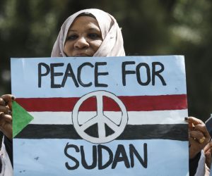 epa07657796 A Sudanese woman looks on with a placard during a protest against Sudan's crackdown on pro-democracy protesters, in Nairobi, Kenya, 19 June 2019. Some 100 people gathered in downtown Nairobi to mourn those who were killed by the Sudanese security forces in Khartoum on 03 June 2019. Kenyan police dispersed the gathering with tear gas.  EPA/DAI KUROKAWA