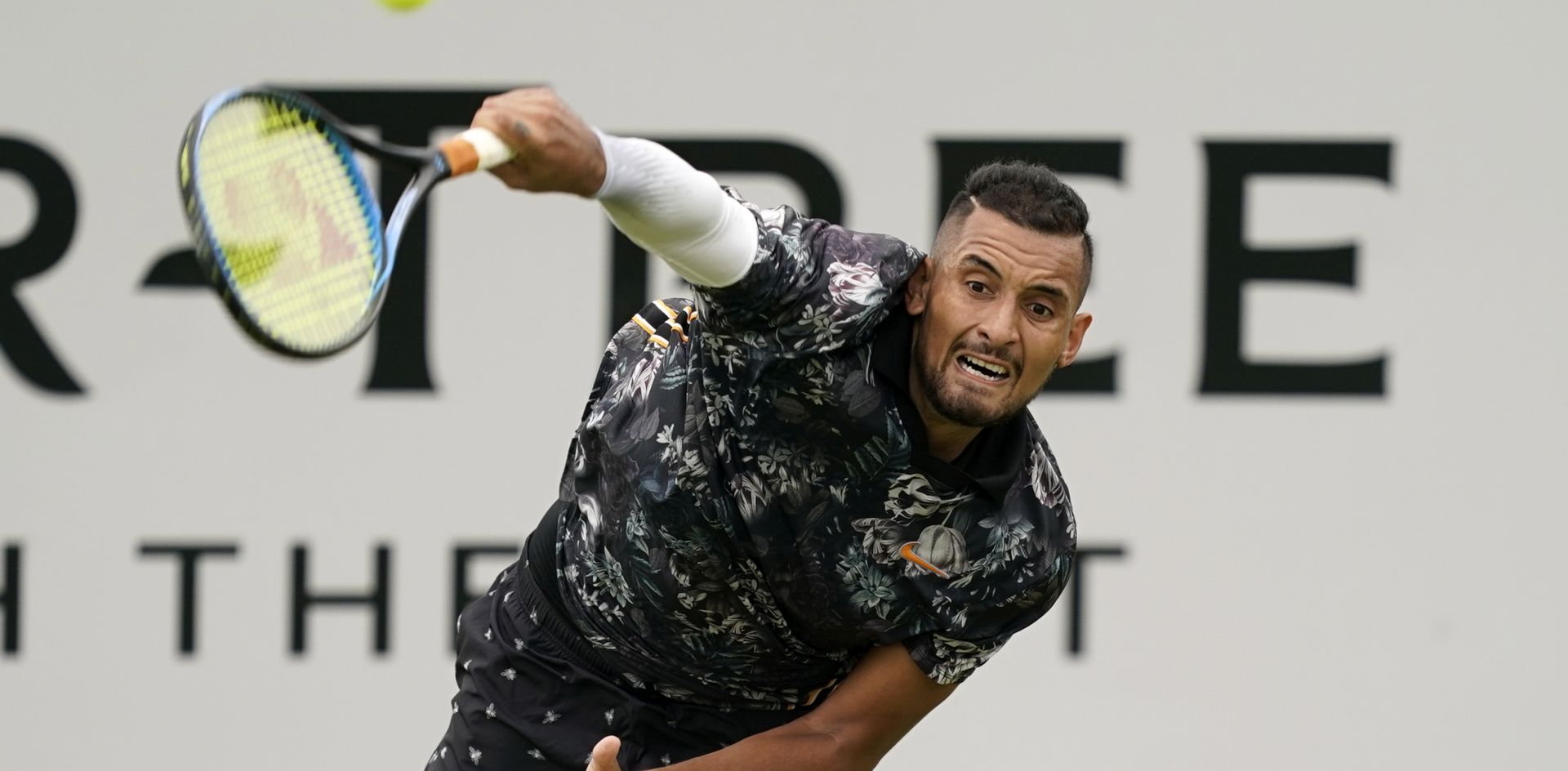 epa07660798 Australia's Nick Kyrgios serves to Spain's Roberto Carballes Baena during their round 32 match at the Fever Tree Championship at Queen's Club in London, Britain, 20 June 2019.  EPA/WILL OLIVER