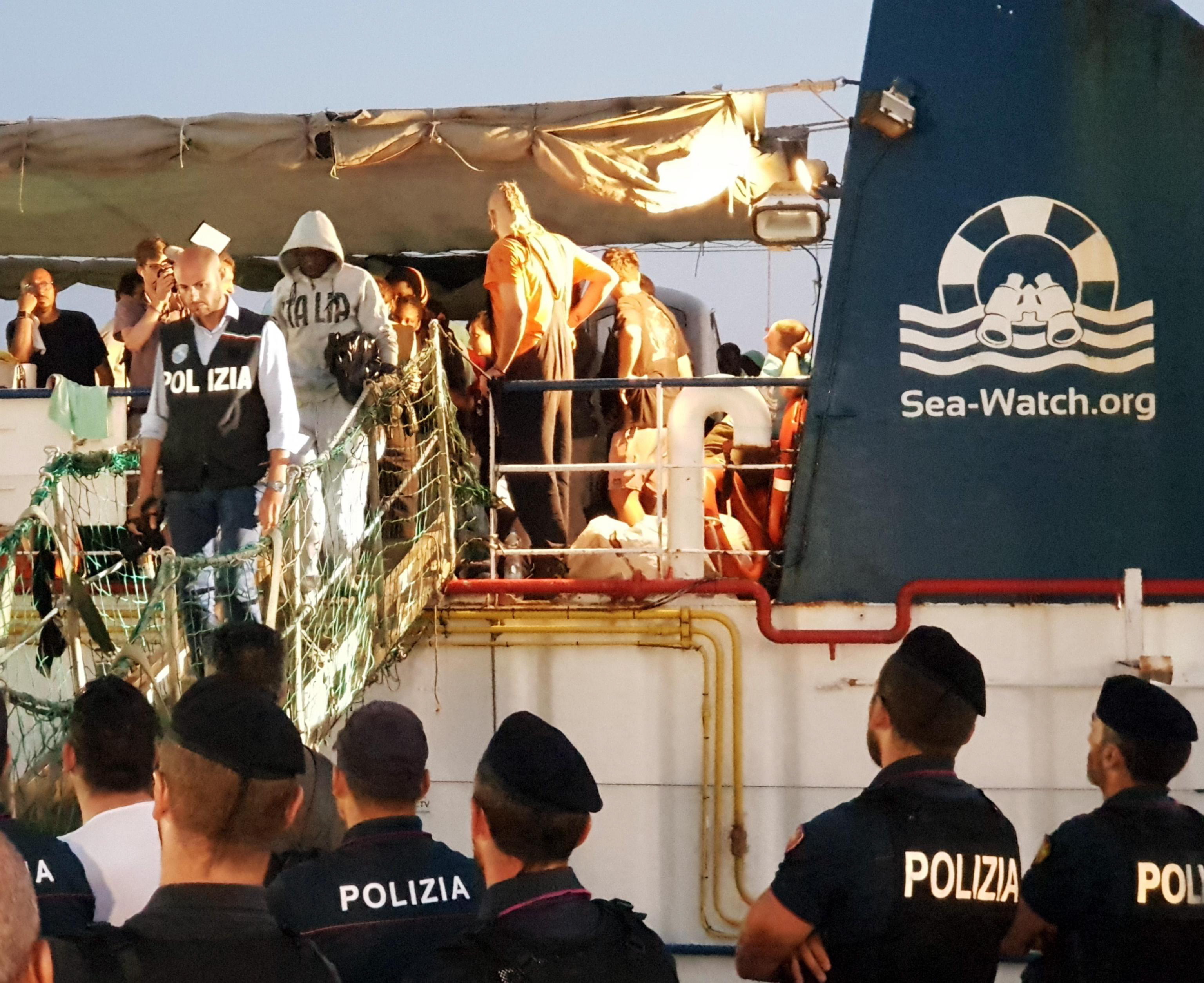 epa07681979 Some of the 40 migrants who were on board the Sea Watch rescue ship disembark at the port of Lampedusa, Italy, 29 June 2019.  According to reports, the captain of the Sea Watch, Carola Rackete, was arrested after entering the port of Lampedusa and ramming a patrol boat.  EPA/ELIO DESIDERIO