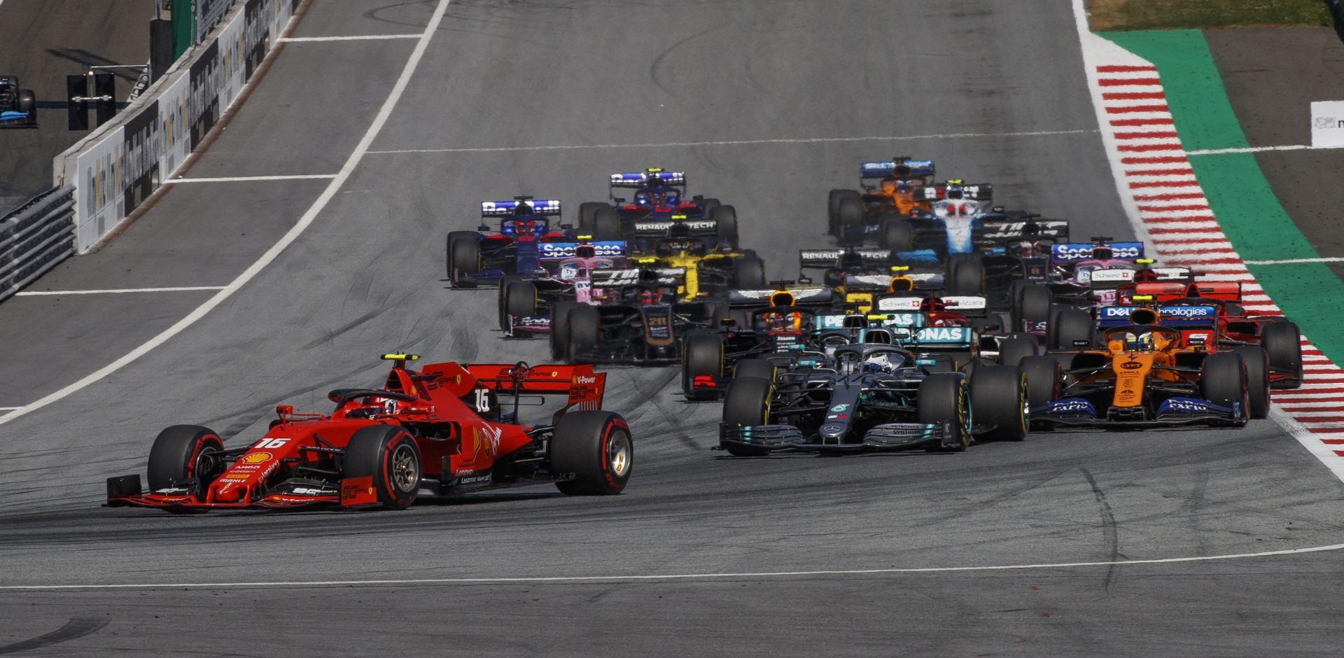 epa07684577 Monaco's Formula One driver Charles Leclerc of Scuderia Ferrari (L) leads the pack of cars during the start of the 2019 Austrian Formula One GP at the Red Bull Ring circuit in Spielberg, Austria, 30 June 2019.  EPA/VALDRIN XHEMAJ