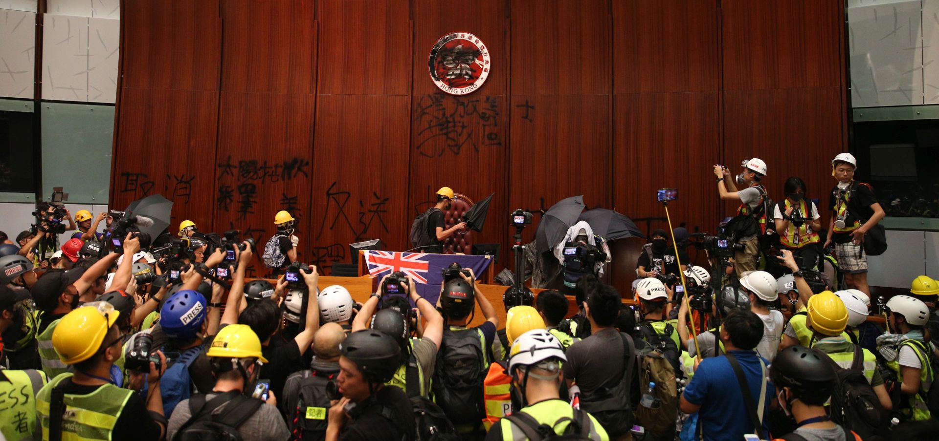 epa07687398 Protesters break into the main chamber of the Legislative Council building during the annual 01 July pro-democracy march in Hong Kong, China, 01 July 2019. Protesters are demanding the resignation of Hong Kong Chief Executive Carrie Lam and the full withdrawal of a suspended extradition bill. On 01 July, Hong Kong marks the 1997 transfer of sovereignty of Hong Kong from Britain to China.  EPA/JEROME FAVRE