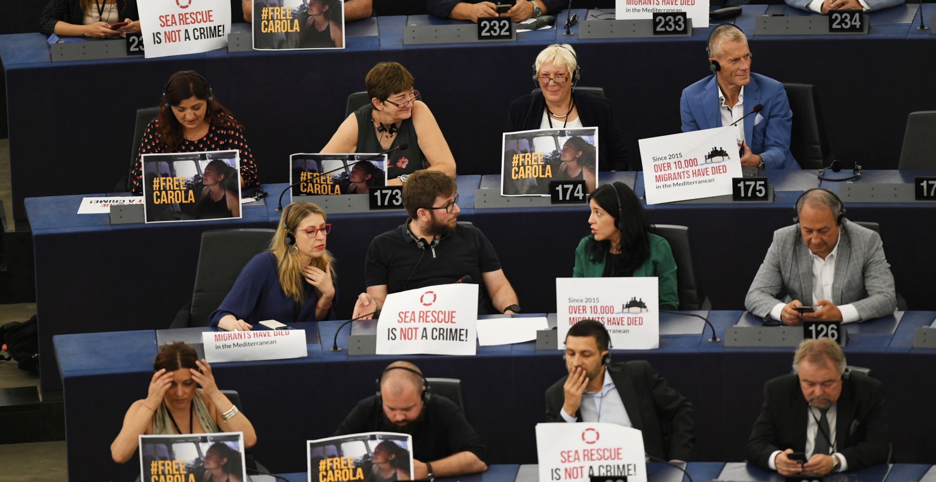 epa07688928 MEPs call for the release of See Watch captain Carola Rakete with signs at the first session of the new Parliament at the European Parliament, in Strasbourg, France, 02 July 2019. German captain Carola Rackete was arrested on 29 June reportedly after violating orders from the Italian Finance Police and entering the port of Lampedusa while ramming a patrol boat on migrant rescue ship 'Sea-Watch 3'.  EPA/PATRICK SEEGER