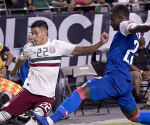 epa07691110 Mexico's Uriel Antuna (L) kicks the ball toward the goal against Haiti's Alex Christian during the semi-final Concacaf Gold Cup match between Haiti and Mexico at State Farm Stadium in Glendale, Arizona, USA, 02 July 2019. Mexico won the match in overtime 1-0.  EPA/RICK D'ELIA
