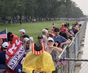 epa07695734 People stand in the rain next to the Lincoln Memorial Reflecting Pool as they wait for US President Donald J. Trump speech during US Independence Day celebrations in Washington, DC, USA, 04 July 2019. The 'Salute to America' Fourth of July activities include remarks by US President Donald J. Trump, a parade, military flyovers and fireworks.  EPA/ERIK S. LESSER