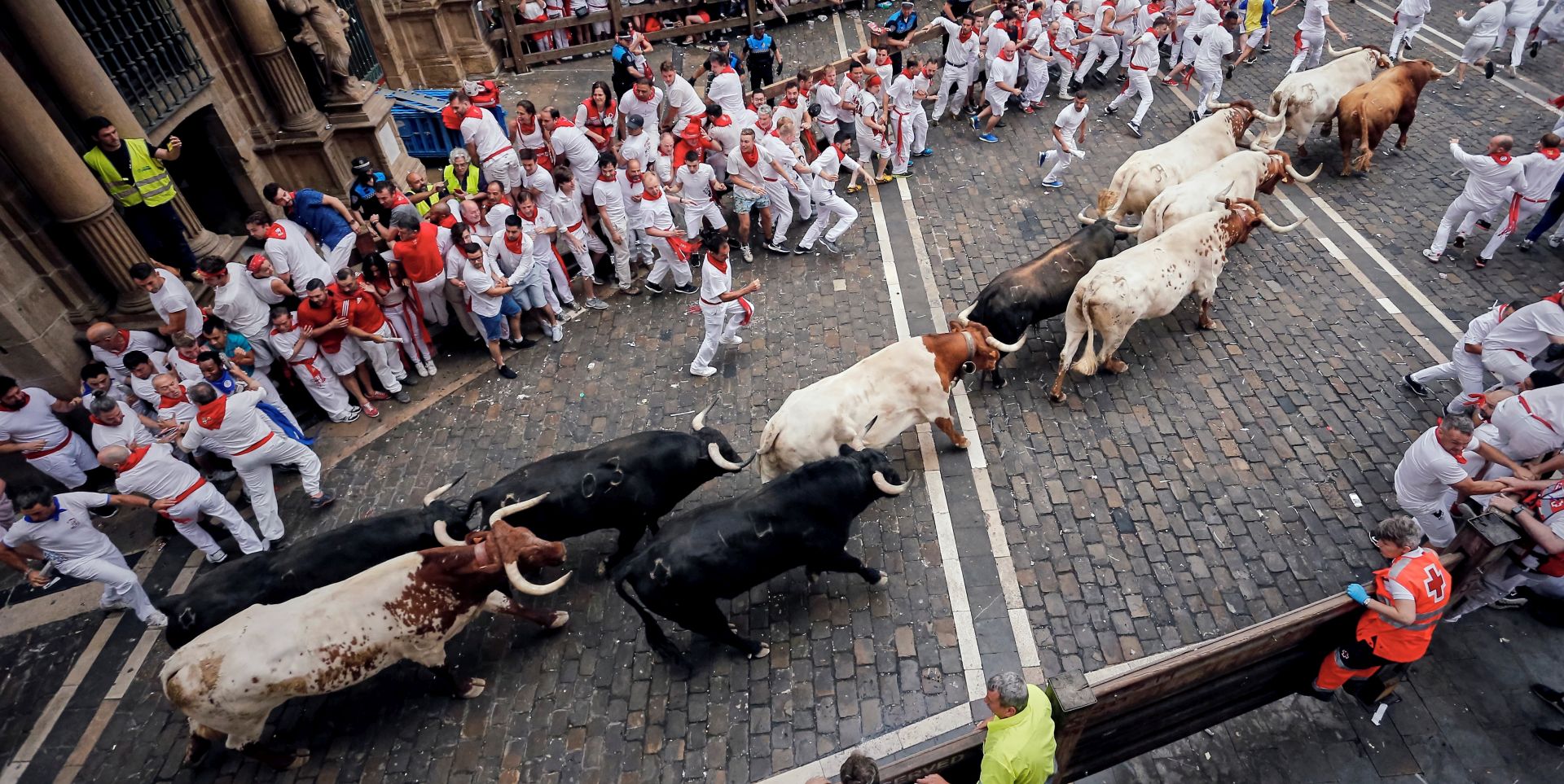 epa07700725 Bulls of the Puerto de San Lorenzo bull ranch run down a street during the traditional San Fermin bull run in Pamplona, Spain, 07 July 2019. The festival, locally known as Sanfermines, is held annually from 06 to 14 July in commemoration of the city's patron saint. Hundreds of thousands of visitors from all over the world attend the fiesta, with many of them physically participating in the highlight event - the running of the bulls, or encierro.  EPA/JAVIER LIZON