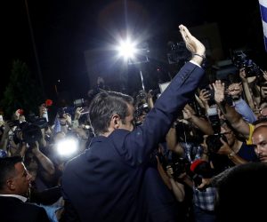 epa07702044 Leader of conservative New Democracy, Kyriakos Mitsotakis (C) waves to supporters after the announcement of the first results of the Greek general elections, at the headquarter's party, in Athens, Greece, 07 July 2019. The result (100 pct of sample) of the first exit polls for the 2019 general elections in Greece were released after the closing of the polls at 19:00 on Sunday. They indicate a victory by a substantial margin for New Democracy, which is seen getting an absolute majority in parliament.  EPA/YANNIS KOLESIDIS