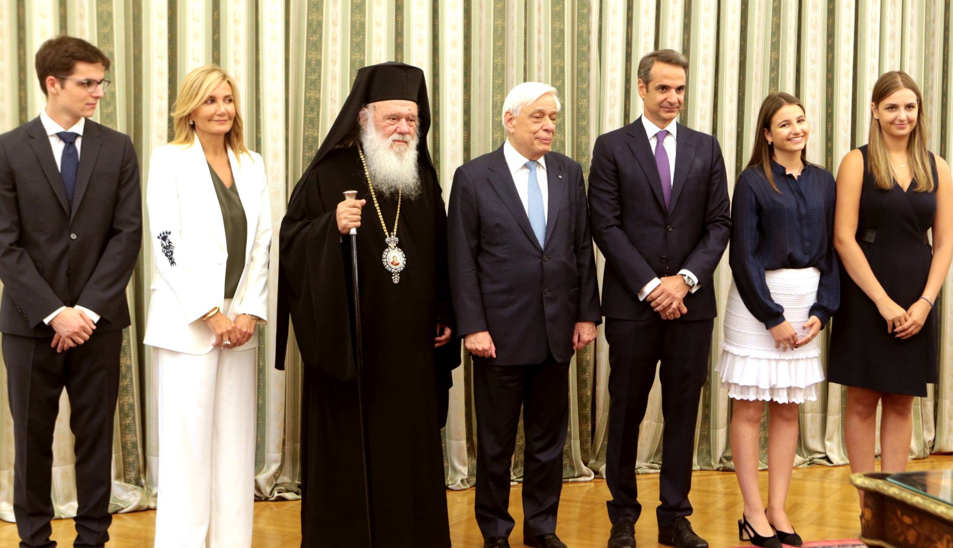 epa07703032 New Greek Prime Minister Kyriakos Mitsotakis (3-R) poses for a photo with Greek President Prokopis Pavlopoulos (C), Greek Archbishop Ieronymos II (3-L), Mitsotakis' wife Mareva Grabowski (2-L) and his children, Konstantinos (L), Dafni (R) and Sophia (2-R) after his swearing-in ceremony at the presidential palace in Athens, Greece, 08 July 2019. The center-right New Democracy party won general elections in Greece on 07 July and will form a majority government. A total of six parties will enter parliament based on the results. Voter participation reached 57.92 percent.  EPA/PANTELIS SAITAS