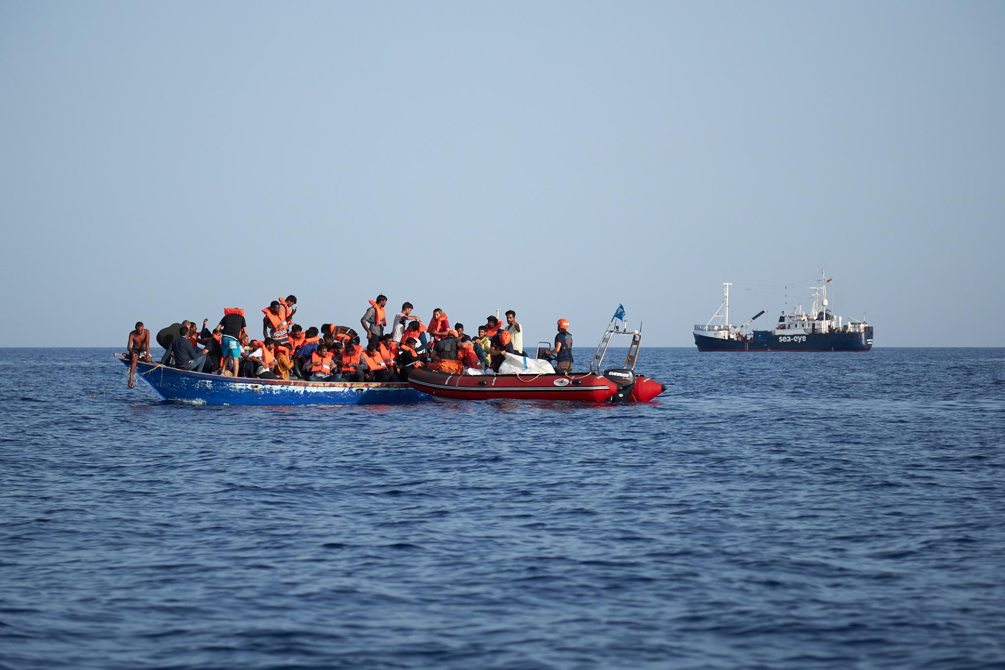 epa07704799 A handout photo made available by German civil sea rescue organisation sea-eye shows a boat carrying migrants (L) and a rescue boat of sea-eye, in the Mediterranean Sea, 08 July 2019 (issued 09 July 2019). According to sea-eye, 44 people were rescued from a woodden boat floating in the Mediterranean between Malta and Lampedusa. The migrants were taken onboard the Alan Kurdi rescue vessel operated by sea-eye and are expected to be transferred to land by the Maltese Navy.  EPA/FABIAN HEINZ / SEA-EYE HANDOUT  HANDOUT EDITORIAL USE ONLY/NO SALES