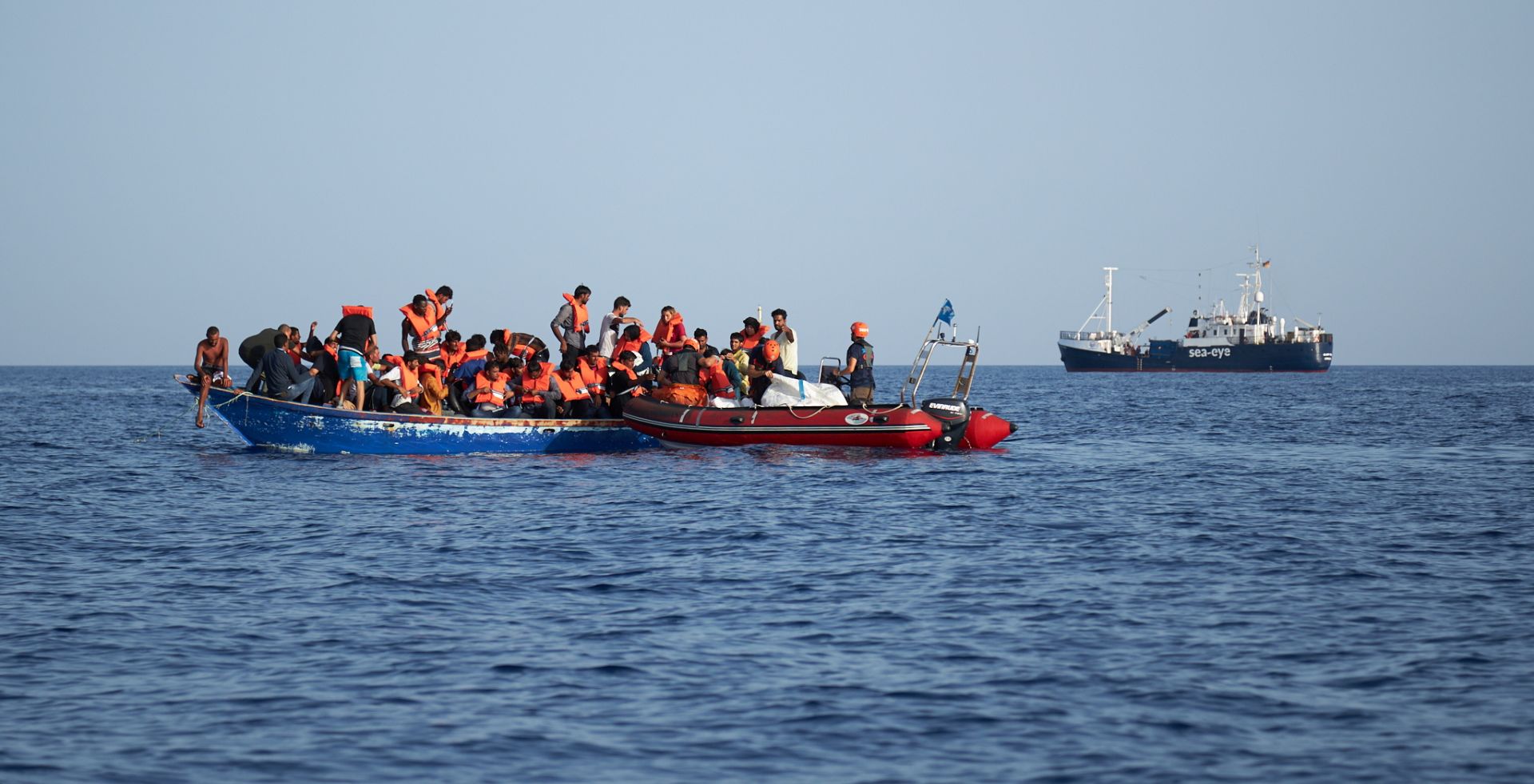 epa07704799 A handout photo made available by German civil sea rescue organisation sea-eye shows a boat carrying migrants (L) and a rescue boat of sea-eye, in the Mediterranean Sea, 08 July 2019 (issued 09 July 2019). According to sea-eye, 44 people were rescued from a woodden boat floating in the Mediterranean between Malta and Lampedusa. The migrants were taken onboard the Alan Kurdi rescue vessel operated by sea-eye and are expected to be transferred to land by the Maltese Navy.  EPA/FABIAN HEINZ / SEA-EYE HANDOUT  HANDOUT EDITORIAL USE ONLY/NO SALES