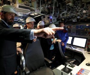 epa07711990 French President Emmanuel Macron (2-L) listens in the navigation and operations center during a visit of the new French nuclear submarine Suffren in Cherbourg, north-western France, 12 July 2019, as part of its official launch ceremony. The 99-metre-long black steel monster is named after Pierre-Andre Suffren, an admiral who distinguished himself against the English in the 18th century. The actual launch will only take place at the end of July, with a three-year delay, before dockside tests, then at sea, and its delivery to the French Navy in Toulon before summer 2020.  EPA/LUDOVIC MARIN / POOL  MAXPPP OUT