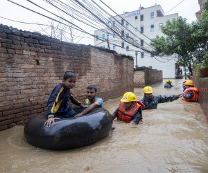 epa07712284 Members of armed police force rescue people from flooded houses following torrential rains in Kathmandu, Nepal, 12 July 2019. Meteorologists warned of heavy monsoon rains in Nepal that put several parts of the country at risk of floods and landslides.  EPA/NARENDRA SHRESTHA
