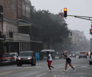 epa07713278 People run from the rain in the French Quarter as Tropical Storm Barry approaches in New Orleans, Louisiana, USA, on 12 July 2019. Tropical Storm Barry is predicted to make landfall as a Category 1 hurricane.  EPA/DAN ANDERSON