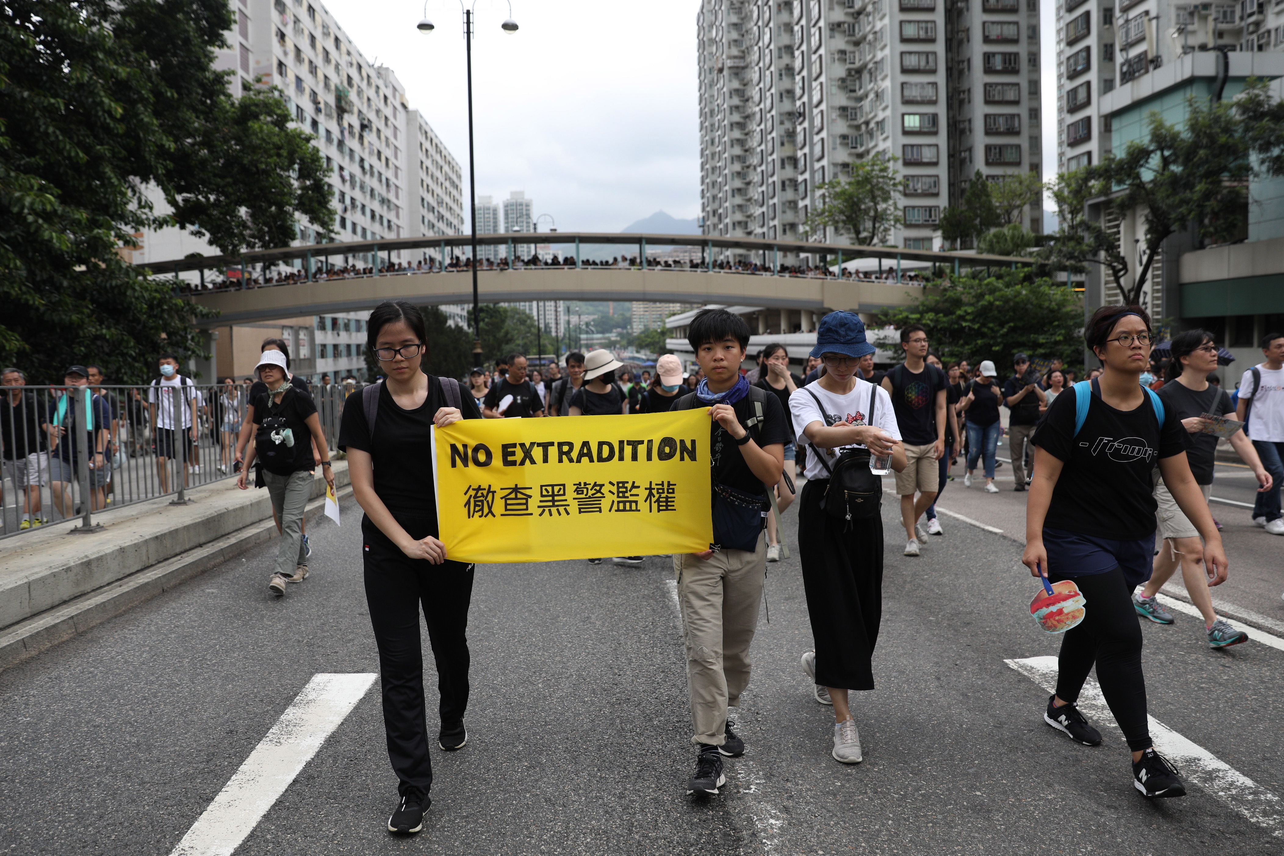 epa07715889 Anti-extradition bill protesters hold a banner 'No Extradition' as they march during a rally in Shatin, Hong Kong, China, 14 July 2019. Spurred by the momentum of the anti-extradition movement, the protesters are demanding the complete withdrawal of the extradition bill, which would have allowed the transfer of fugitives to mainland China, and unconditional release of all arrested protesters among other demands.  EPA/JEROME FAVRE