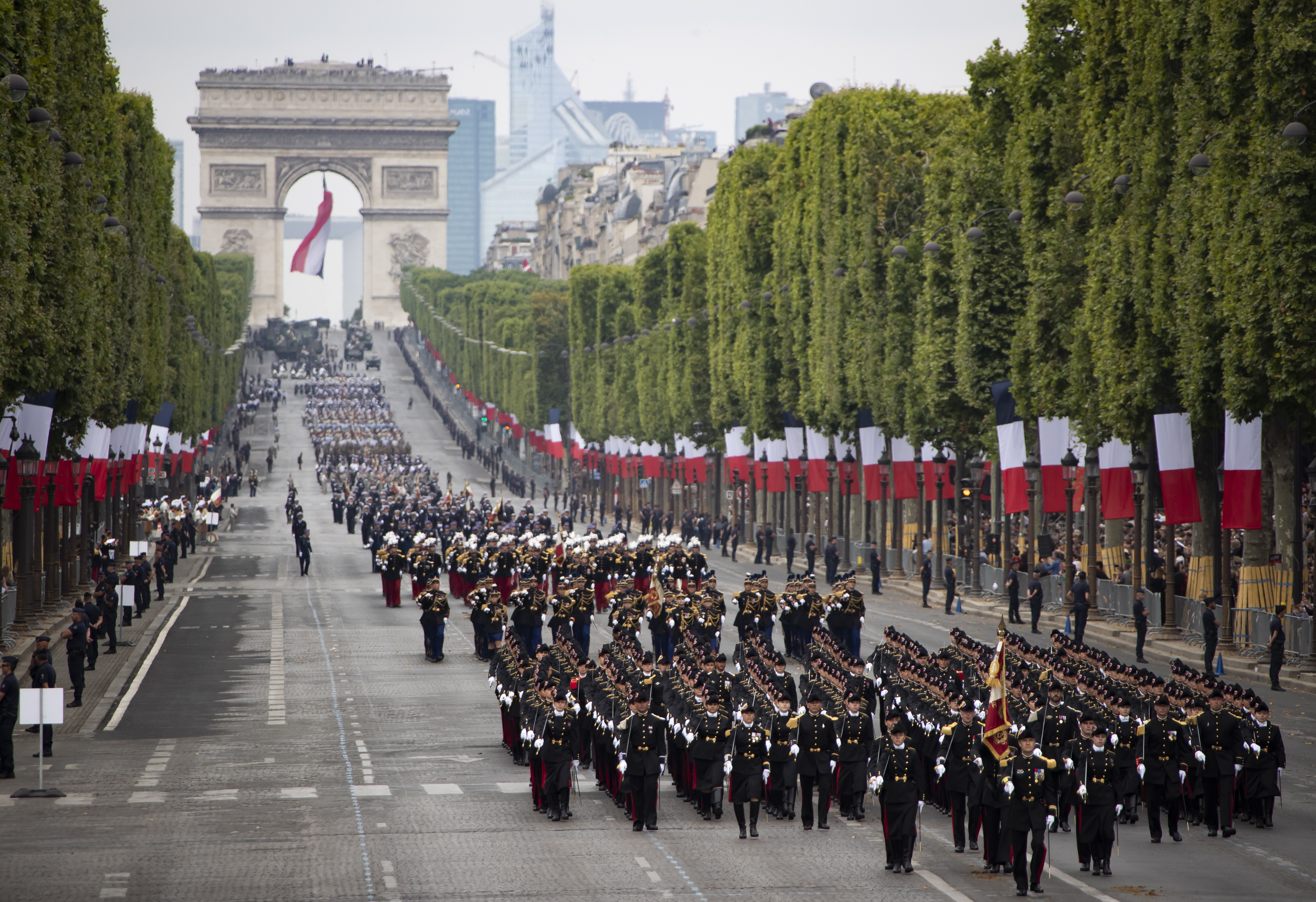 epa07716192 A general view of troops marching during the annual Bastille Day military parade on the Champs Elysees avenue in Paris, France, 14 July 2019. Bastille Day, the French National Day, is held annually on 14 July to commemorate the storming of the Bastille fortress in 1789.  EPA/IAN LANGSDON