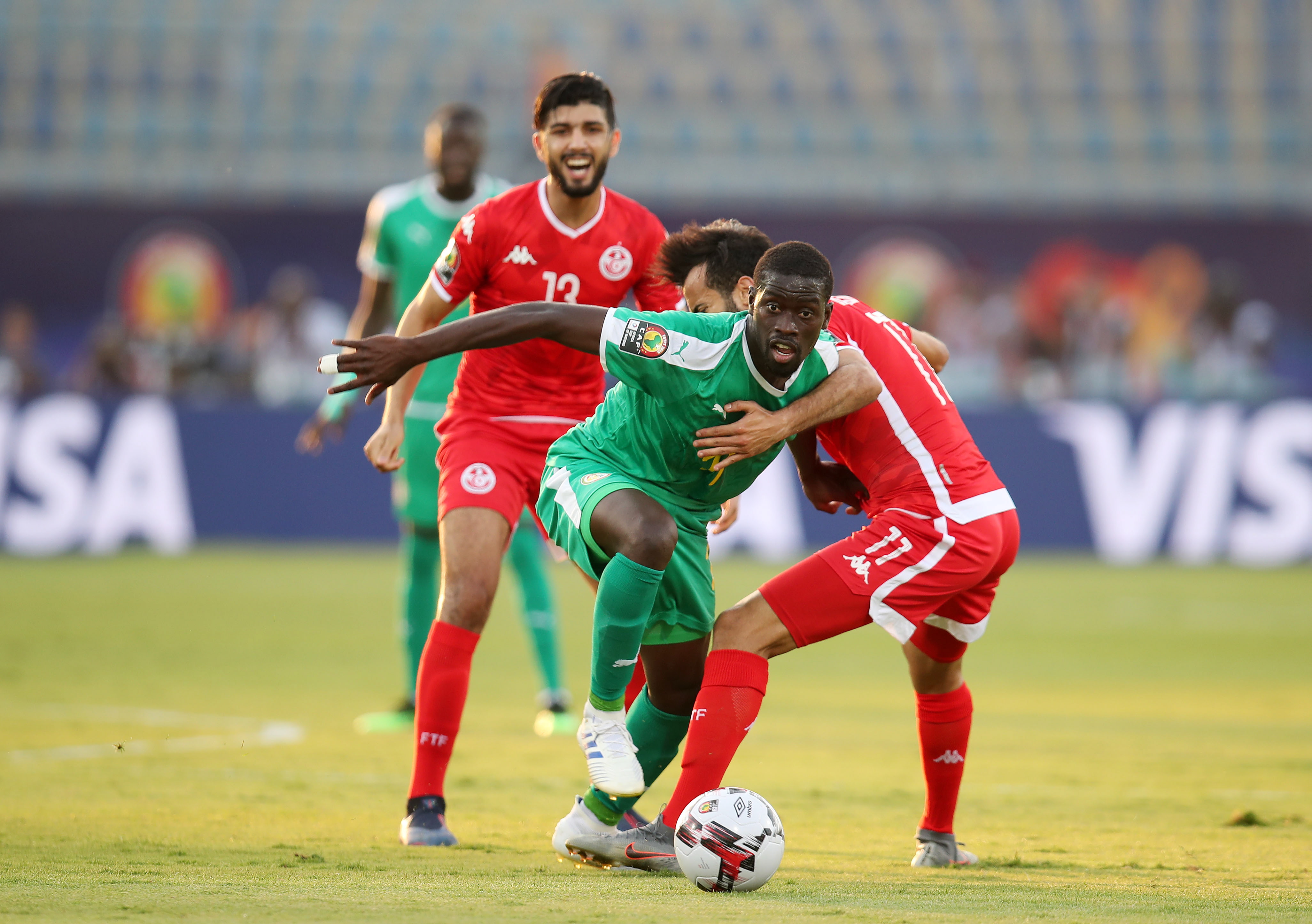 epa07717123 Papa Alioune Ndiaye of Senegal (front) challenged by Taha Yassine Khenissi of Tunisia during the 2019 Africa Cup of Nations Semifinal match between Senegal and Tunisia at the 30 June Stadium, Cairo on the 14 July 2019.  EPA/MUZI NTOMBELA