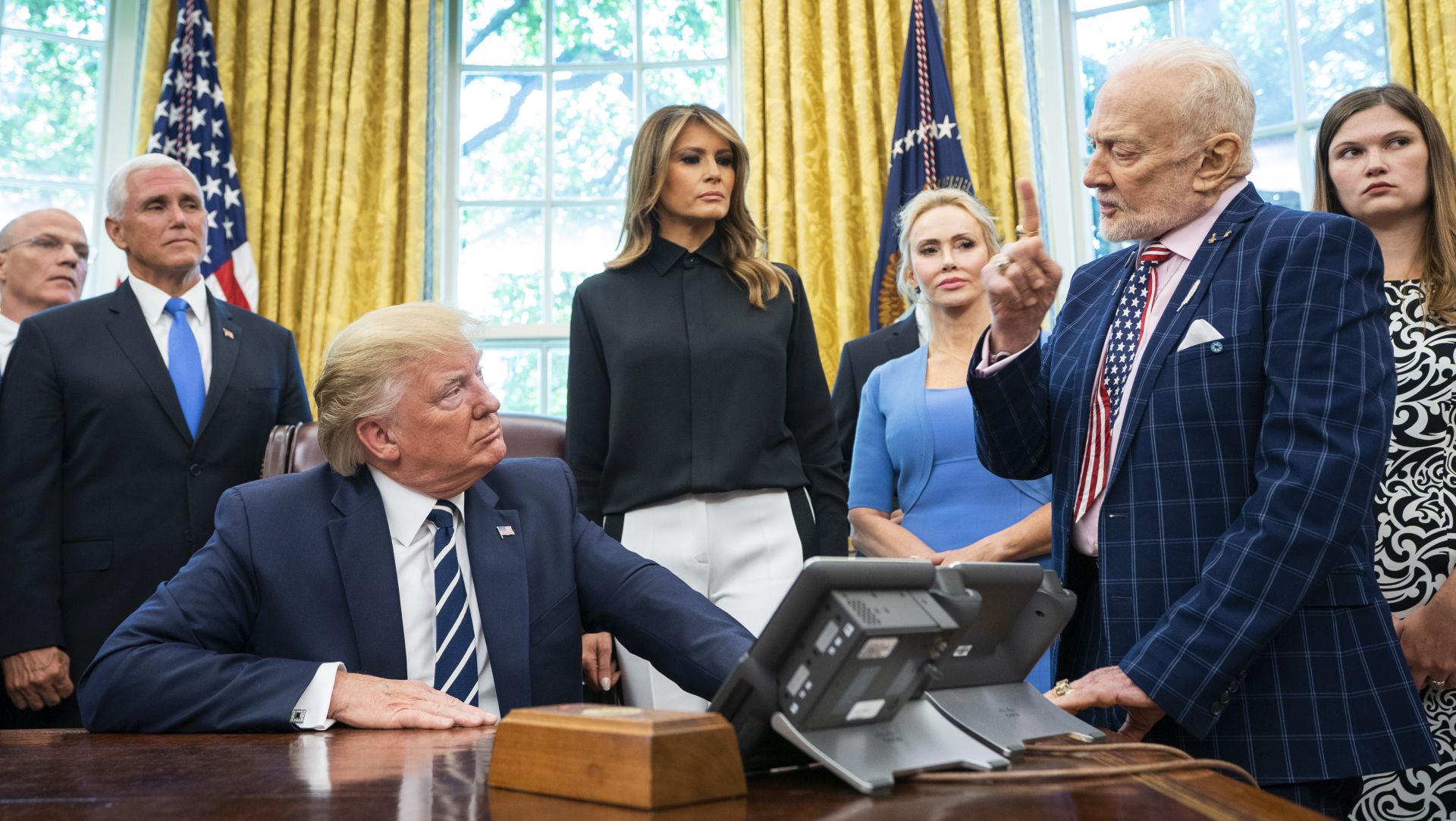 epa07727620 US President Donald J. Trump (C) welcomes astronauts Buzz Aldrin (R), Michael Collins (not pictured), and the family of Neil Armstrong to the Oval Office honor the 50th anniversary of the Apollo moon landing in the Oval Office of the White House in Washington, DC, USA, 18 July 2019. The president also answered questions about his racist tweet, and the Iranian drone shot down by American forces.  EPA/JIM LO SCALZO
