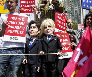 epa07729343 Anti Brexit protesters with puppets depicting Jeremy Hunt (L) and Boris Johnson (R) and placards 'Boris & Hunt are Farage's Puppets' take part in the No to Boris, Yes to EU March in London, Britain, 20 July 2019. Thosuands of people gathered to march against Brexit and Boris Johnson to likely be named as the new British Prime Minister.  EPA/HOLLIE ADAMS