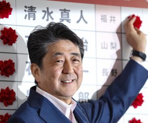epa07731429 Japanese Prime Minister and the ruling Liberal Democratic Party (LDP) President, Shinzo Abe, puts red rose marks on the names of the party's victorious candidates in the Upper House election, at the LDP headquarters in Tokyo, Japan, 21 July 2019. Exit polls suggest that Abe's LDP and its junior coalition partner, Komeito, will win over half of the seats being contested for the Upper House.  EPA/KIMIMASA MAYAMA