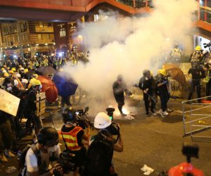 epa07731558 Riot police shoot tear gas while anti-extradition bill protesters take part in a rally in Hong Kong, China, 21 July 2019. The organizer of the march, the Civil Human Rights Front, is urging the government to set up an independent commission of inquiry to be led by a judge, to look into the policing of recent extradition protests. The Front originally planned to march from Victoria Park to the Court of Final Appeal in Central but the police said the march must end in Wan Chai instead for public safety reasons.  EPA/JEROME FAVRE