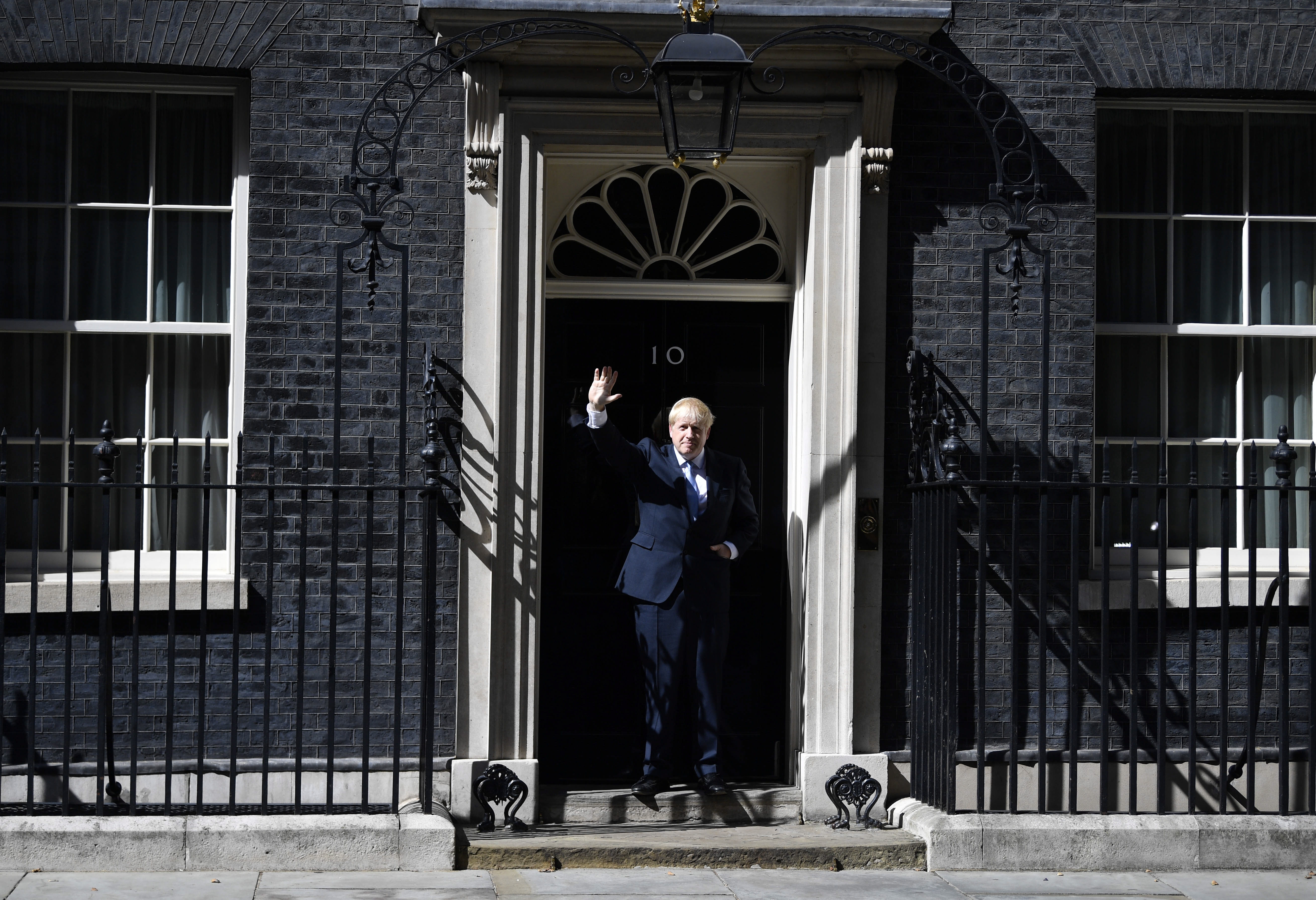 epa07737699 British Prime Minister Boris Johnson waves as he enters 10 Downing Street following his appointment by the Queen in London, Britain, 24 July 2019. Former London mayor and foreign secretary Boris Johnson is taking over the post after his election as party leader was announced the previous day. Theresa May stepped down as British Prime Minister following her resignation as Conservative Party leader on 07 June.  EPA/NEIL HALL