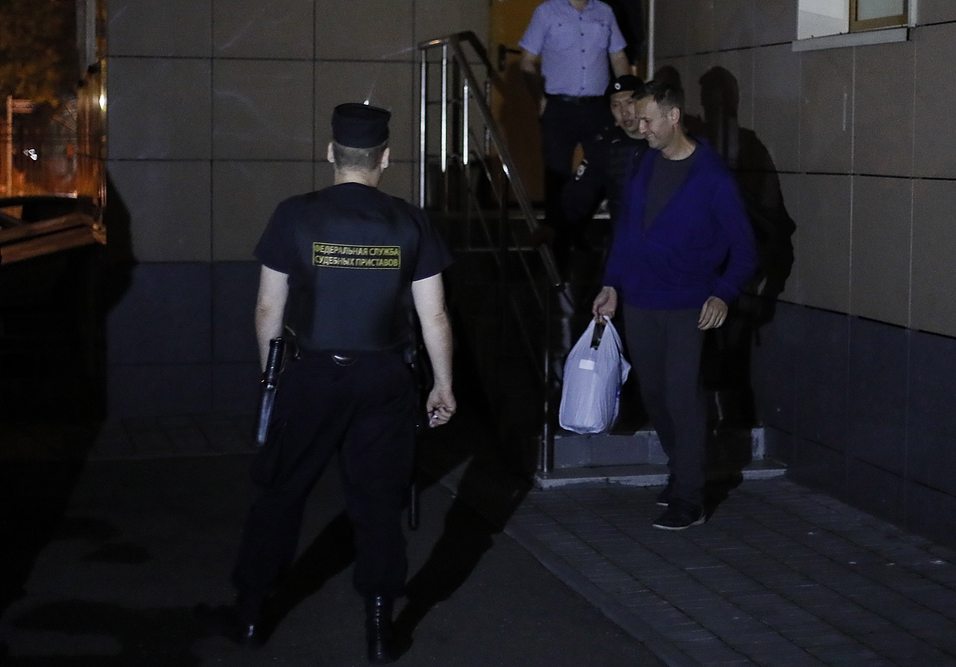 epa07738436 Russian policemen escort Russian liberal opposition leader Alexei Navalny (R) to a car after a court session at Simonovsky District court in Moscow, Russia, late 24 July 2019. Alexei Navalny was again arrested on 24 July 2019 while leaving his house for jogging. The Simonovsky District Court of Moscow arrested Alexei Navalny, the founder of the Anti-Corruption Foundation, for 30 days for appealing to participate in an unauthorized protest action on 27 July in Moscow.  EPA/SERGEI ILNITSKY