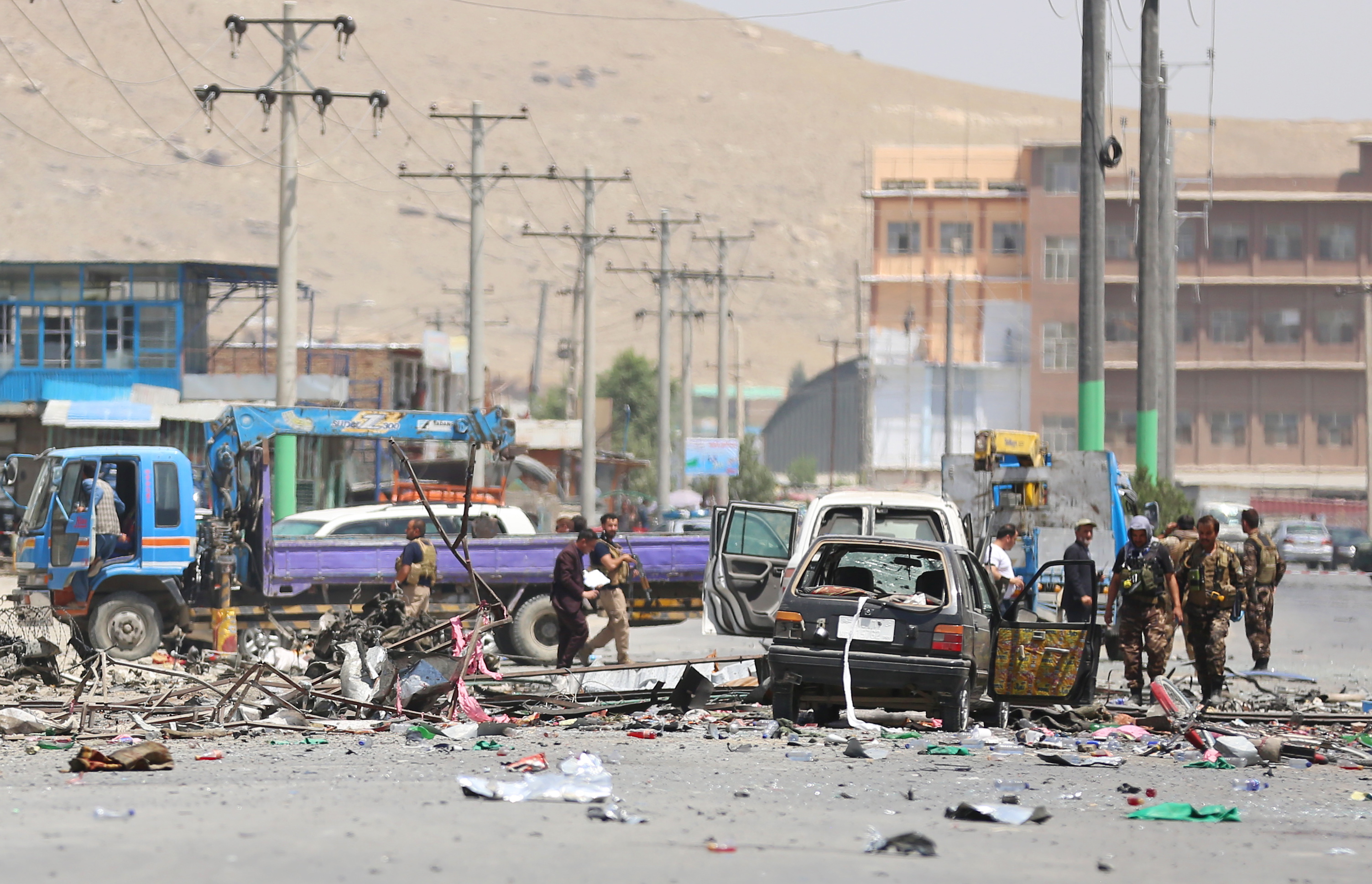 epa07739146 Afghan security forces inspect the scene of a suicide attack in Kabul, Afghanistan, 25 July 2019. A series of three back-to-back bombs in the Afghan capital Kabul on 25 July left at least seven people dead and 21 wounded, officials said.  EPA/JAWAD JALALI