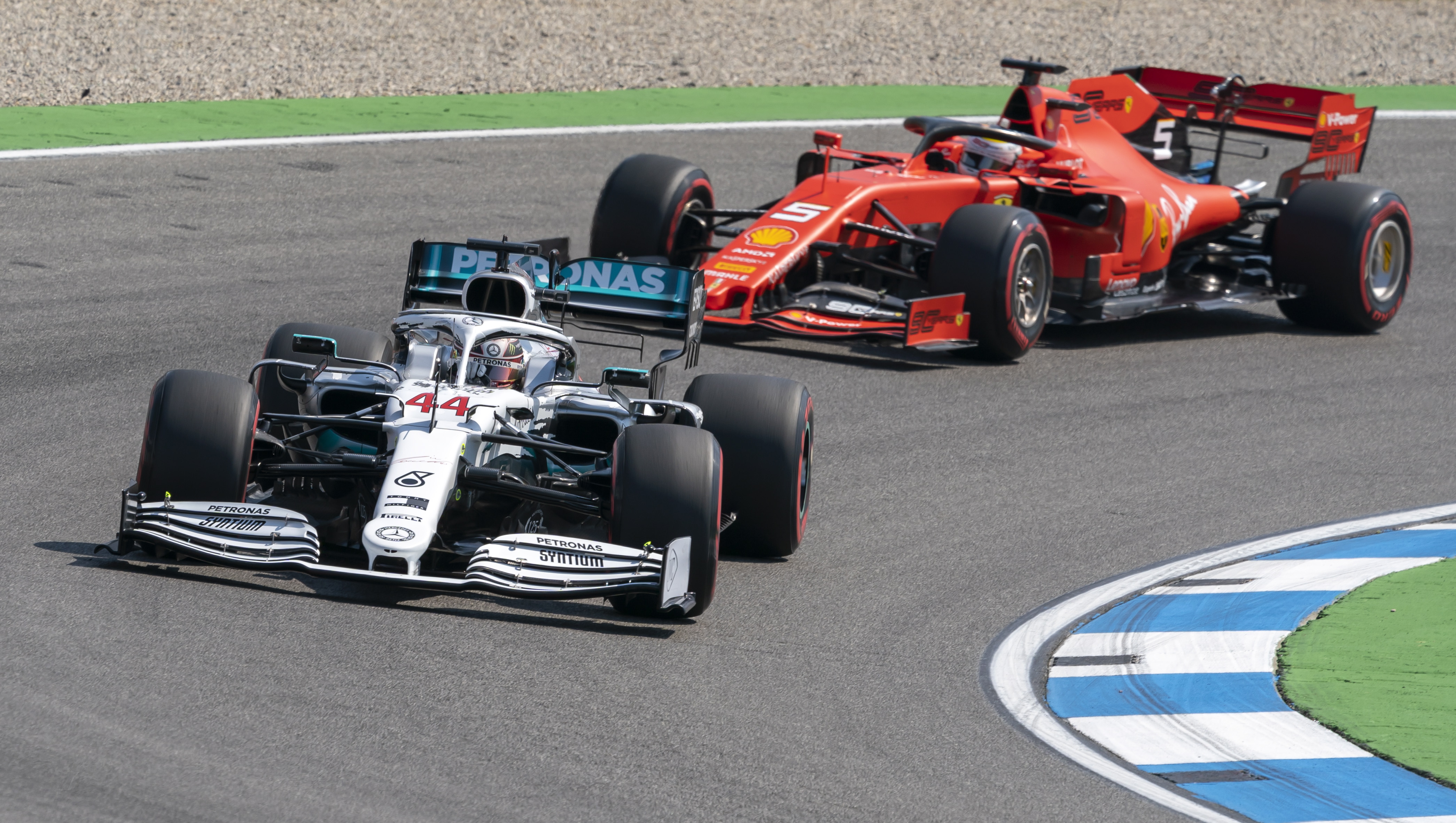 epa07741688 British Formula One driver Lewis Hamilton (L) of Mercedes AMG GP and German Formula One driver Sebastian Vettel (R) of Scuderia Ferrari in action during the first practice session of the 2019 Formula One Grand Prix of Germany at Hockenheim Ring circuit in Hockenheim, Germany, 26 July 2019. The 2019 Formula One Grand Prix of Germany will take place on 28 July.  EPA/RONALD WITTEK
