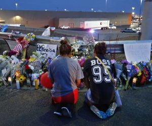 epa07757275 Two women kneel to pray at a make shift memorial at the site of a mass shooting at a Walmart in El Paso, Texas, USA, 04 August 2019. A day earlier, 20 people killed and 40 injured in a mass shooting at the Walmart in El Paso, Texa Prosecutors said that they will seek the death penalty against Patrick Crusiuss, a 21-year-old man, accused of the mass shooting.  EPA/LARRY W. SMITH