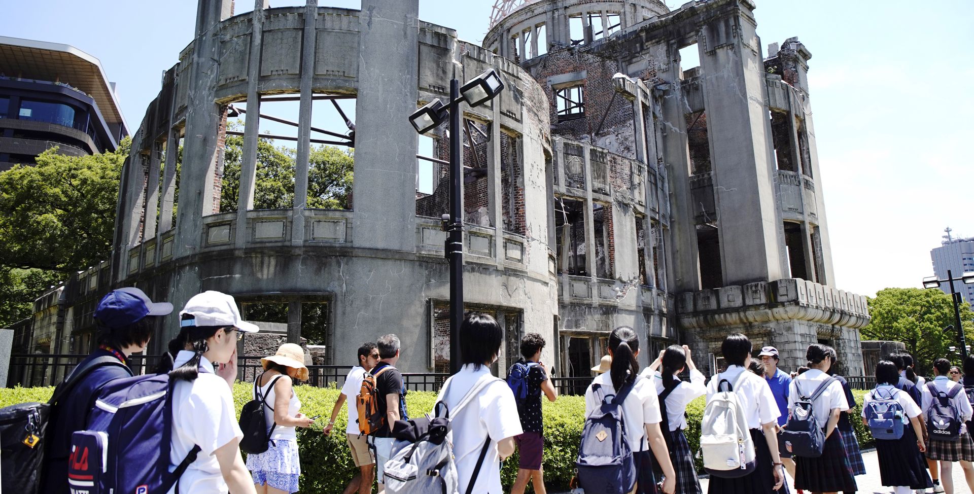 epa07757888 School students walk before the Atomic Bomb Dome at Hiroshima Peace Memorial Park in Hiroshima, western Japan, 05 August 2019. Hiroshima will mark 74th anniversary of the atomic bombing on 06 August 2019.  EPA/JIJI PRESS JAPAN OUT EDITORIAL USE ONLY/  NO ARCHIVES