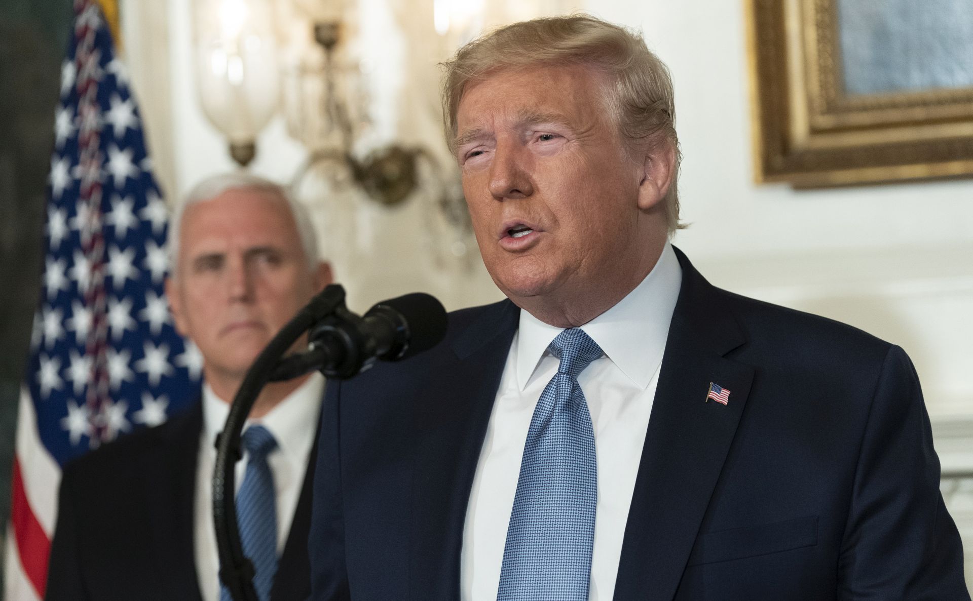 epa07757952 US President Donald J. Trump makes a statement at the White House in Washington, DC, USA, on 05 August 2019 in response to two separate shooting incidents. US Vice President Mike Pence looks on from left.  EPA/Chris Kleponis / POOL
