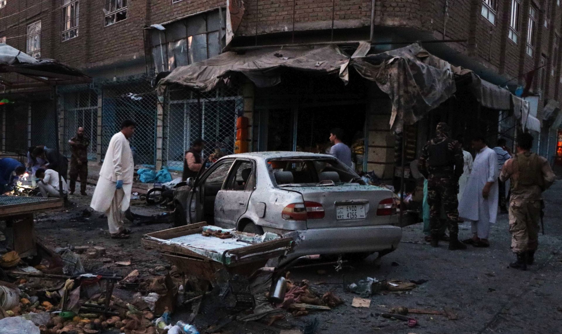 epa07758248 Afghan security officials inspect the scene of a bomb blast in Herat, Afghanistan, 05 August 2019. At least four people were killed and 25 others injured when a bomb exploded in Herat.  EPA/JALIL REZAYEE