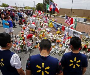 epa07759591 Three Walmart employees pause while visiting the make shift memorial after the mass shooting that happened at a Walmart in El Paso, Texas, USA, 06 August 2019. Twenty two people were killed and 26 injured during a mass shooting at the Walmart on 03 August 2019. Prosecutors said they will seek the death penalty against Patrick Crusius, a 21-year-old man, accused of the mass shooting.  EPA/LARRY W. SMITH