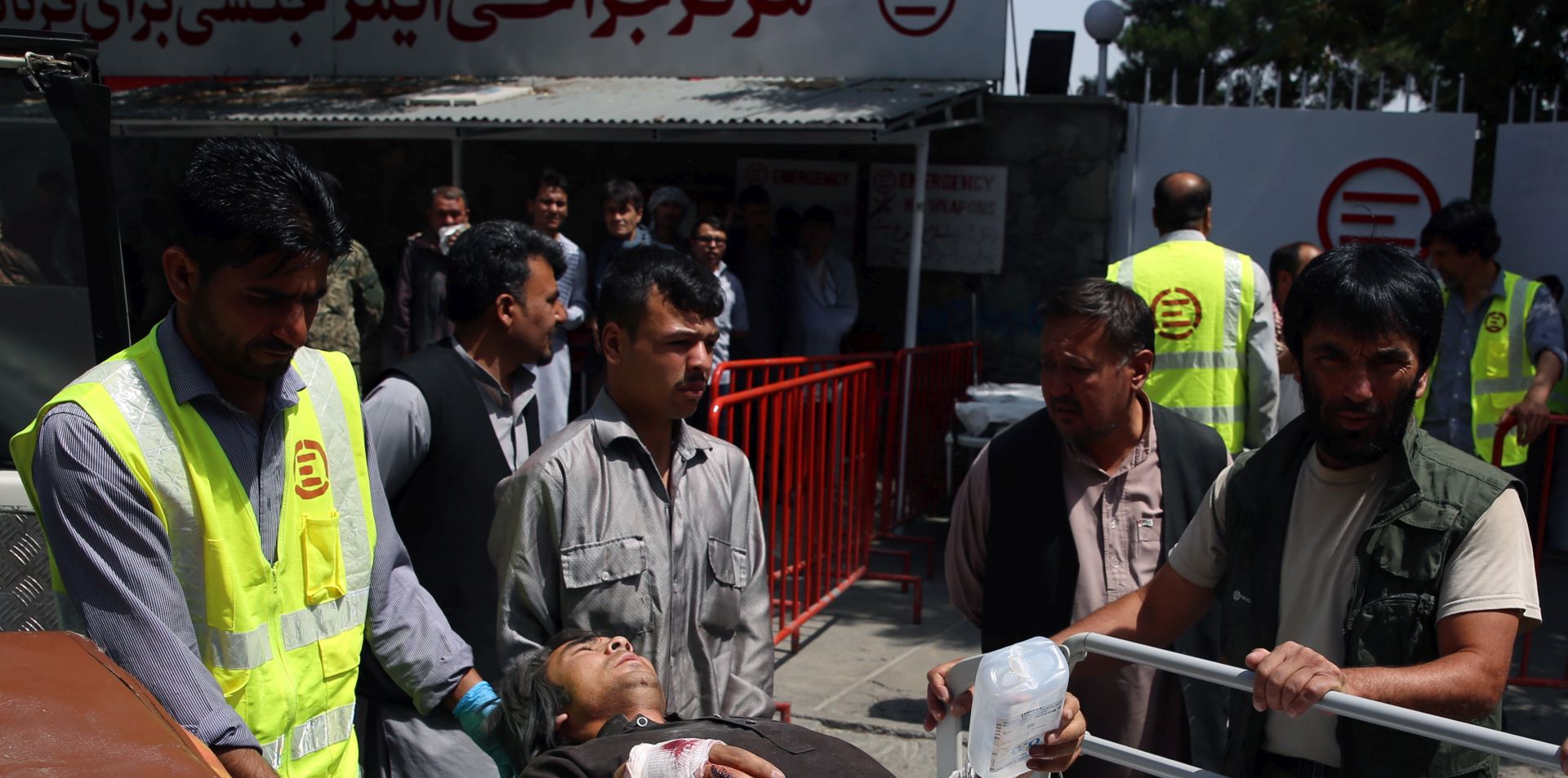 epa07759916 Afghan health workers transport a wounded man to a hospital after bomb explosion and gun fight that targeted a police station in a heavy residential area of Kabul, Afghanistan, 07 August 2019. According to reports, at least 95 people were wonded in the attack.  EPA/JAWAD JALALI