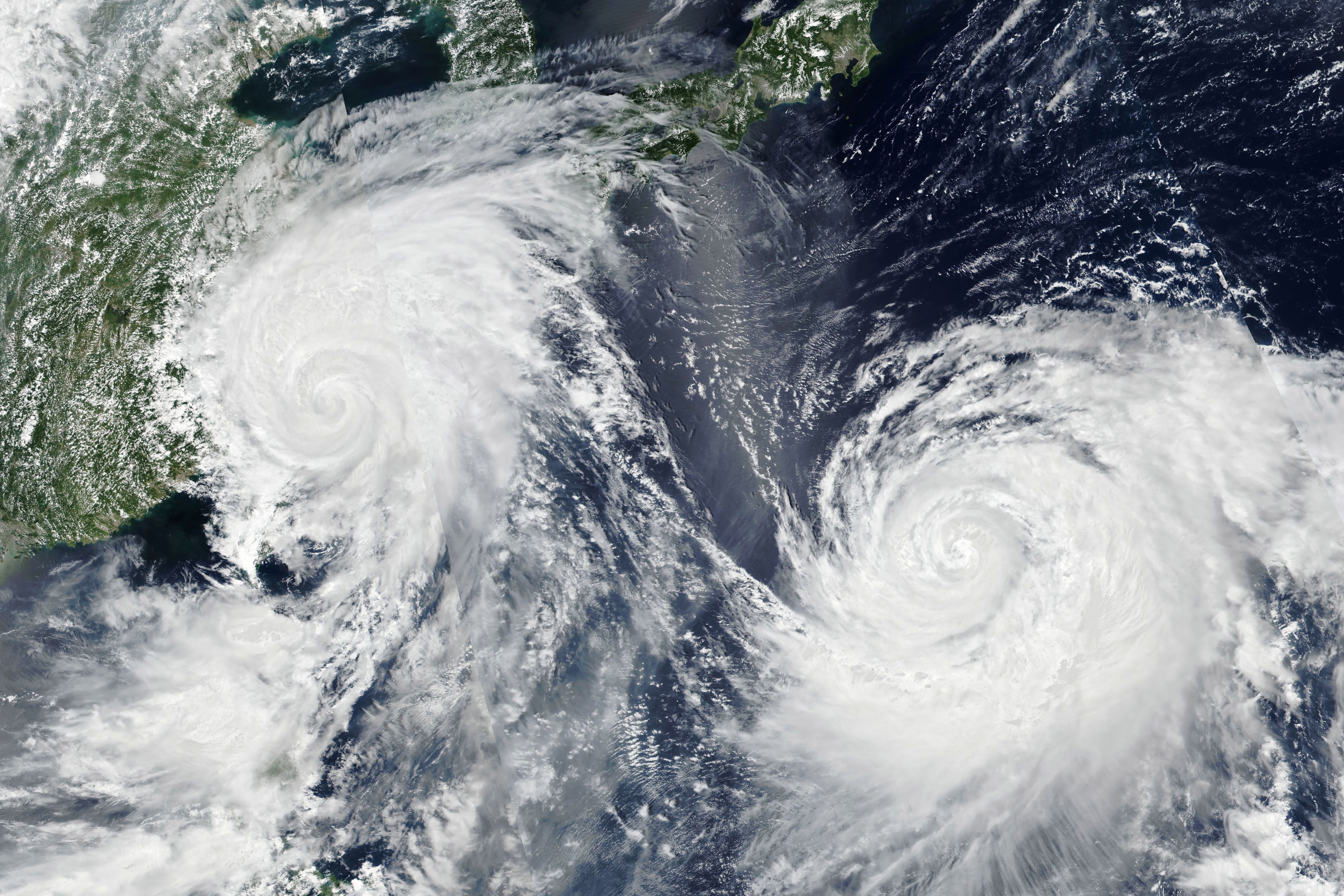 epa07765366 A handout photo made available by NASA Earth Observatory shows a satellite image of Typhoon Lekima (L) and Typhoon Krosa (R) crossing the Western Pacific Ocean, 09 August 2019, threatening East Asian countries with destructive winds and rain. Typhoon Lekima made landfall near Shitangzhen, in China's Zhejiang province on 10 August 2019 at around 1 a.m. local time. Chinese authorities on 09 August issued a red alert warning residents of strong winds, heavy rainfall and coastal impacts threats in anticipation of the typhoon's landfall. Meanwhile Typhoon Krosa continues to follow a northerly path toward Japan, but its forecasted track remains uncertain.  EPA/NASA EARTH OBSERVATORY HANDOUT  HANDOUT EDITORIAL USE ONLY/NO SALES
