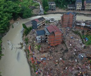 epa07766442 Aerial view of the landslide site beside a river in Yongjia county in east China's Zhejiang province in China, 10 August 2019. According to news reports, at least 22 people have been killed, ten are still missing and more than a million made to evacuate as Typhoon Lekima hits China 10 August 2019.  EPA/FEATURECHINA CHINA OUT