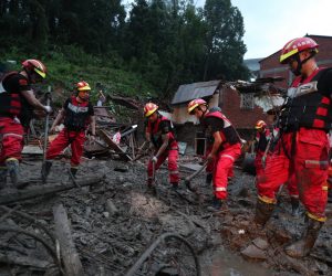 epa07766440 Rescuers work on the landslide triggered by Typhoon Lekima in Yongjia county in east China's Zhejiang province in China, 10 August 2019. According to news reports, at least 22 people have been killed, ten are still missing and more than a million made to evacuate as Typhoon Lekima hits China 10 August 2019.  EPA/FEATURECHINA CHINA OUT