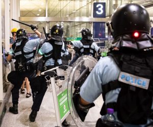 epa07771729 Riot police clash with anti-government protesters in Hong Kong Chek Lap Kok International Airport, Hong Kong, China, 13 August 2019. Air passengers are facing a second day of disruption as most outbound flights from Hong Kong were again cancelled on 13 August as thousands of anti-government protesters occupied the airport terminal. Hong Kong has been gripped for weeks by mass protests, which began in June 2019 over a now-suspended extradition bill to China and have developed into an anti-government movement.  EPA/LAUREL CHOR