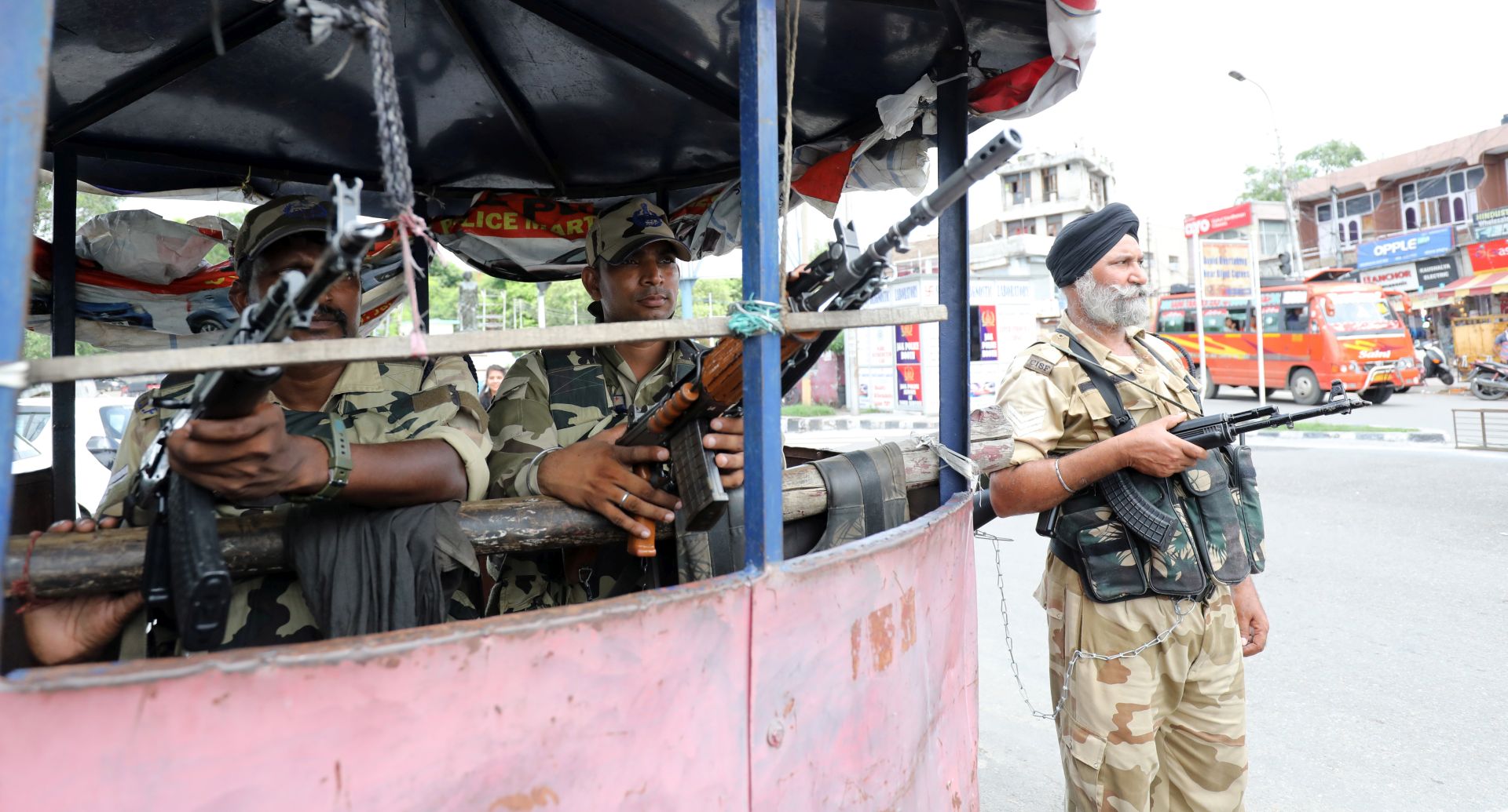 epa07772670 Indian paramilitary soldiers stand guard near barricade in Jammu, the winter capital of Kashmir, India, 14 August 2019. The Indian government on 05 August moved a resolution in the parliament that removed the special constitutional status granted to the disputed Kashmir region. The Indian Kashmir region has been under heavy lockdown since then and security is on the high alert ahead of Independence Day celebrations across the country.  EPA/JAIPAL SINGH