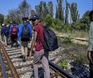epa07772811 A group of Pakistani illegal migrants walk on the railroad by the town of Veles, Republic of North Macedonia on 14 August 2019. Reports state that they have been traveling from the Greek - North Macedonian border to the town of Veles  (around 100 km) for seven days. Although the Balkan migrant route has been officially closed since 03 March 2016, small groups of migrants are still illegally passing the border between Greece and North Macedonia and travel through North Macedonia on their way to western Europe. Some travel this road by foot, while others use the transport offered by migrant smugglers. Beside the North Macedonian police and army, the border with Greece is being patrolled by police forces from other European countries.  EPA/GEORGI LICOVSKI
