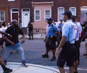 epaselect epa07773975 Philadelphia Police offers clash with bystanders at 15th Street and W Pacific Street in Philadelphia, Pennsylvania, USA, 14 August 2019. A suspect shot at least six Philadelphia police officers, with gunfire continuing for more than one hour. One suspect is in custody and a second suspect is under SWAT surveillance in a house near the intersection of 15th Street and W Erie Ave.  EPA/STRINGER