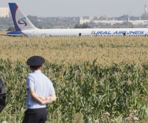 epa07774163 Russian police officers near the site of Ural Airlines A-321 passenger plane emergency landing outside Zhukovsky airport in Ramensky district of Moscow region, Russia, 15 August 2019. A-321 with 226 passengers and seven crew members on board en-route from Moscow to Simferopol made emergency landing after a right engine failure following the plane's colliding with seagulls shortly after take-off. Ten people were hospitalized following the accident.  EPA/SERGEI ILNITSKY