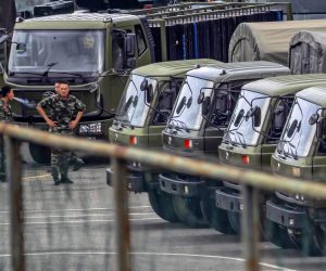 epa07774384 A members of People's Armed Police Force (PAP) walk by vehicles gethered on the Shenzhen Bay Sports Center in Shenzhen , Guangdong Province, China, 15 August 2019.
China has deployed large numbers of paramilitary personnel only 25km, just across the harbor, from the border with Hong Kong. PAP is the 1.5 million-member paramilitary force. On the spot at least thousand members of PAP are seen, along with countless militarized and armored vehicles.  EPA/Alex Plavevski