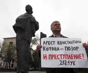 epa07777436 Sergei Mitrokhin, a representative of democratic party Yabloko, and also unregistered candidate, holds a placard reading 'Konstantin Kotov's arrest is a shame and crime! 212.1FC' during a single picket in the center of Moscow, Russia, 17 August 2019. Liberal opposition protest against decision of the Central Elections Commission not to register their candidates for Moscow City Duma elections, which are scheduled on 08 September.  EPA/SERGEI ILNITSKY