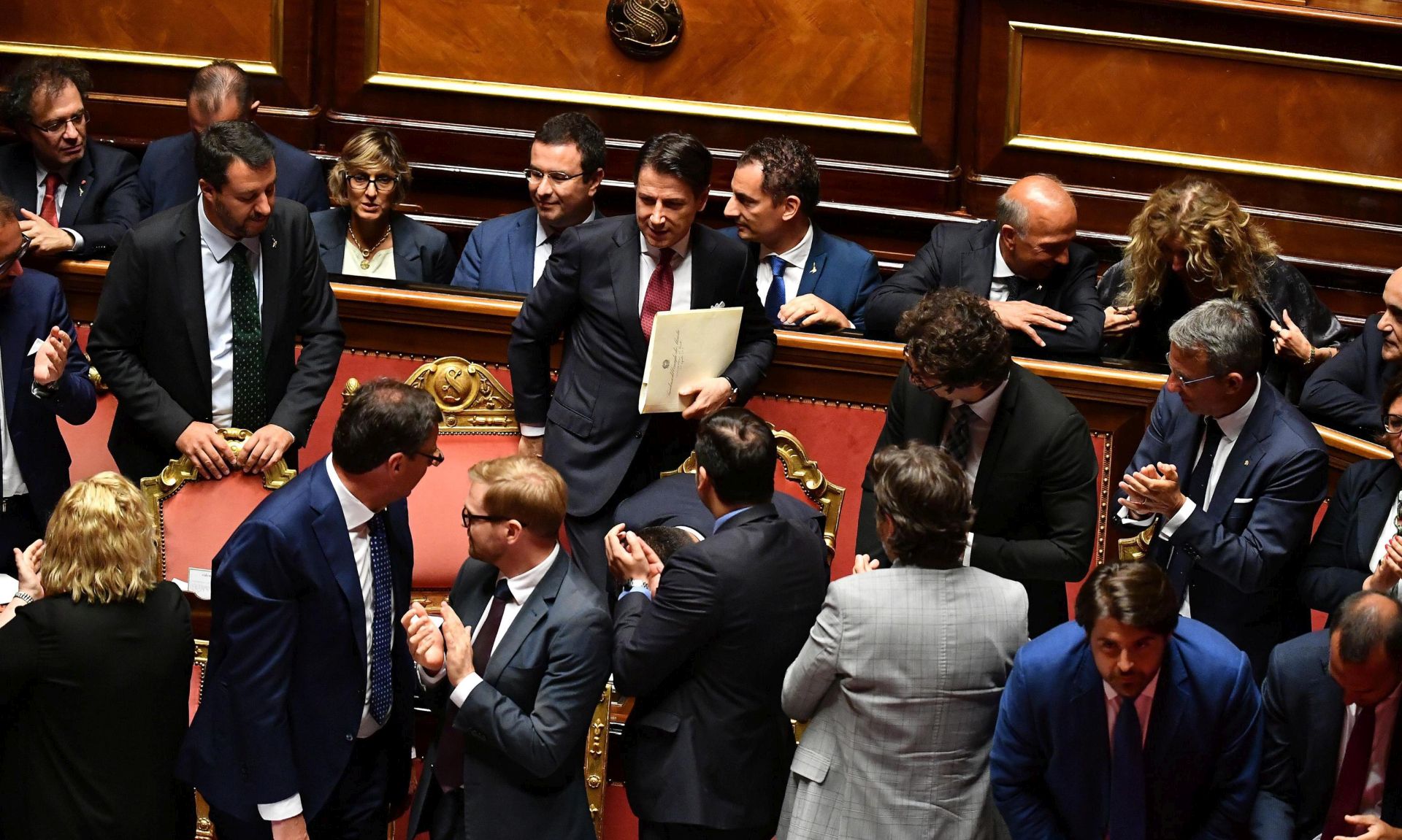 epa07782246 Italian Premier Giuseppe Conte (C) arrives to deliver a speech at the Senate in Rome, Italy, 20 August 2019 as Deputy Premier and Interior Minister Matteo Salvini (L) looks on. Conte in his address called bringing about the government crisis  irresponsible. Salvini and his party League pulled out from government and caused a political crisis a week ago.  EPA/ETTORE FERRARI