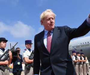 epa07790234 Britain's Prime Minister Boris Johnson (C) arrives at Biarritz Pays Basque Airport in Biarritz to attend the G7 summit, France, 24 August 2019. The G7 Summit runs from 24 to 26 August in Biarritz.  EPA/STEFAN ROUSSEAU / POOL