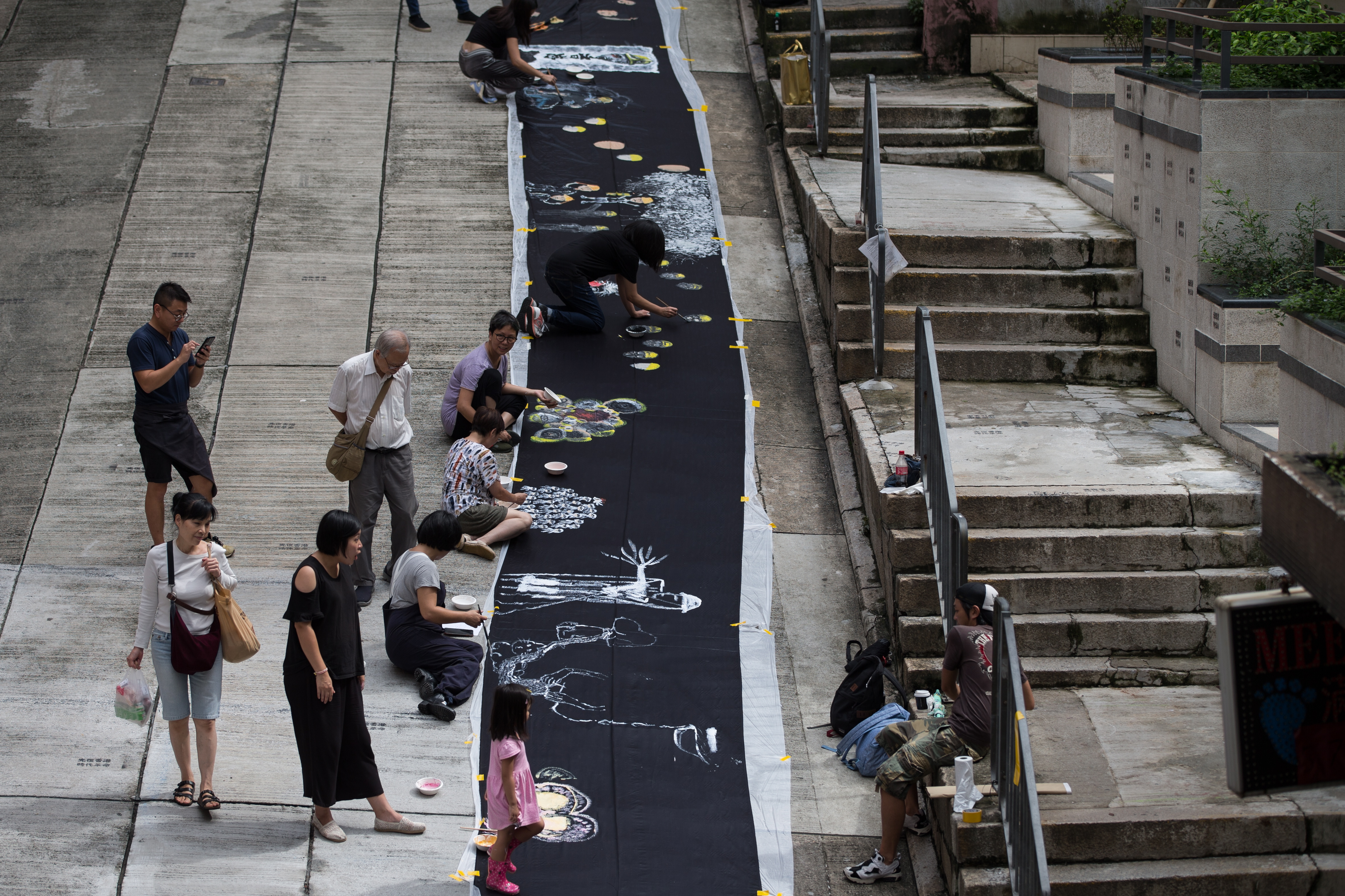 epa07803574 Local artists paint a canvas on the theme of recent protest in Hong Kong, China, 30 August 2019. Hong Kong has been gripped by mass protests since June 2019 over a now-suspended extradition bill that have morphed into an anti-government movement with no end in sight.  EPA/JEROME FAVRE
