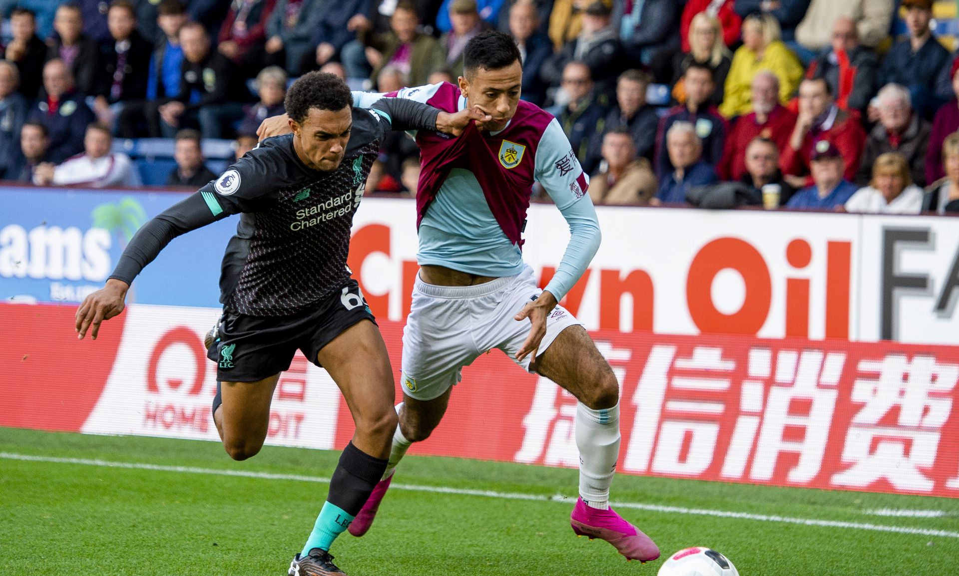 epa07808167 Liverpool's Trent Alexander-Arnold (L) in action with Burnley's Dwight McNeil (R) during the English Premier League soccer match between Burnley and Liverpool held at the Turf Moor in Burnley, Britain, 31 August 2019.  EPA/PETER POWELL EDITORIAL USE ONLY. No use with unauthorized audio, video, data, fixture lists, club/league logos or 'live' services. Online in-match use limited to 120 images, no video emulation. No use in betting, games or single club/league/player publications