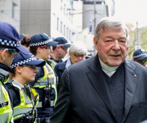 FILE PHOTO - Vatican Treasurer Cardinal George Pell is surrounded by Australian police as he leaves the Melbourne Magistrates Court in Australia FILE PHOTO - Vatican Treasurer Cardinal George Pell is surrounded by Australian police as he leaves the Melbourne Magistrates Court in Australia, October 6, 2017.    REUTERS/Mark Dadswell/File Photo Mark Dadswell