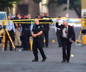 epa07756237 Police officers at the crime scene in Dayton, Ohio, USA, 04 August 2019 following the mass shooting in the Oregon district of Dayton. Media reports state that nine people have been killed and many more injured after a gunman opened fired outside a bar in Dayton. Police confirmed they killed the gunman at the scene.  EPA/TOM RUSSO